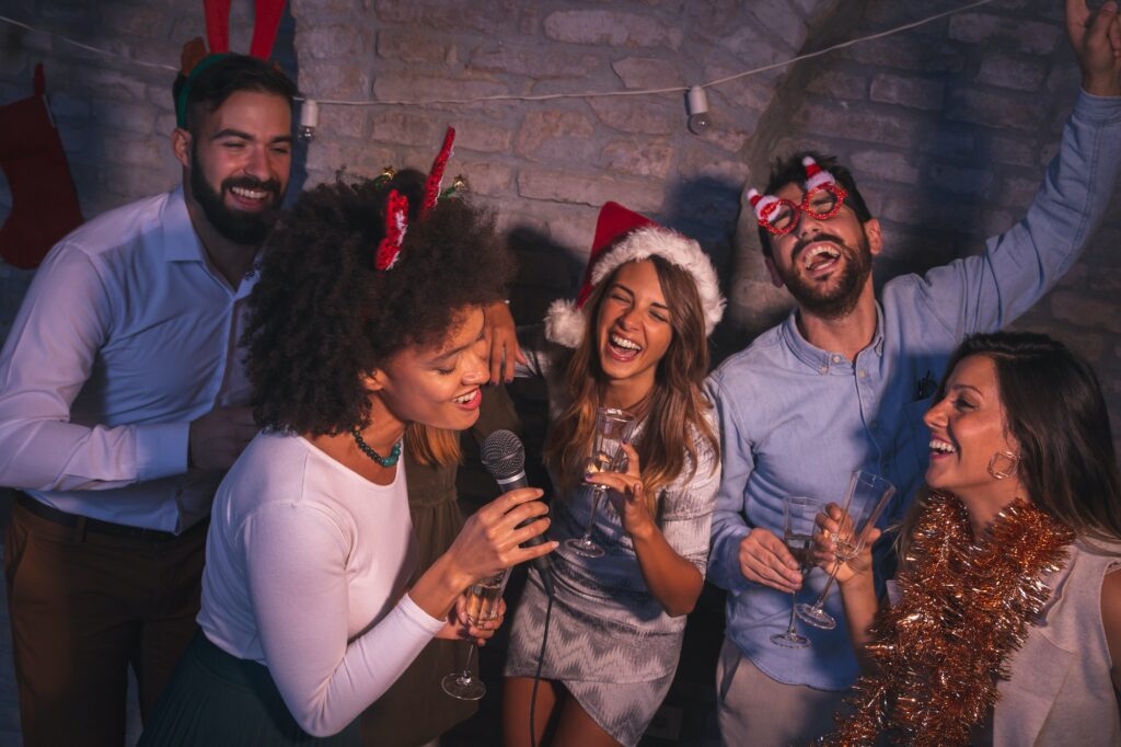 Friends singing karaoke at New Year's Eve party